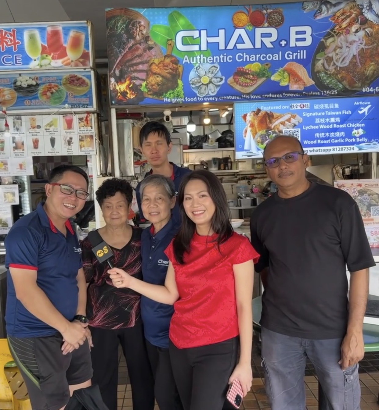 CharB hawker stall with the team being interviewed by a TV reporter